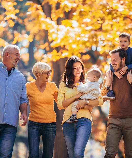 Three generations of family walking happily outdoors