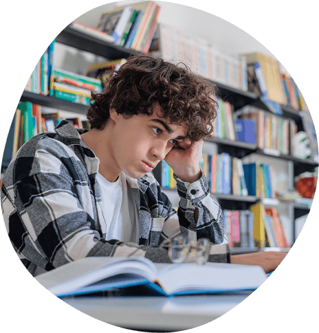 Teenage boy struggling with schoolwork