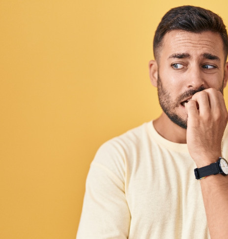 Man biting his fingernails due to anxiety