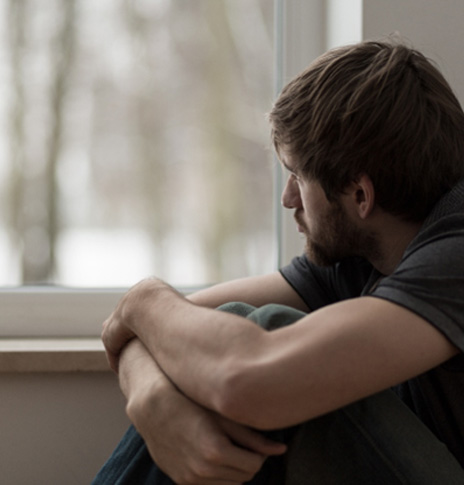 Sad man looking out the window