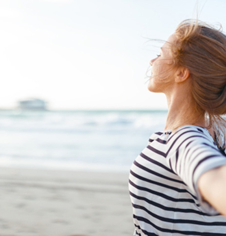 Happy and calm woman enjoying the beach