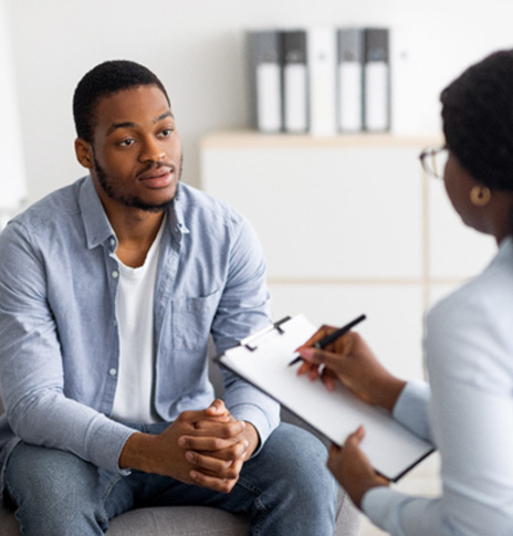 Medical professional taking notes during psychiatric evaluation