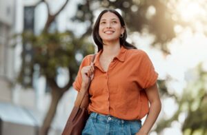 Woman walking outside with a smile on her face